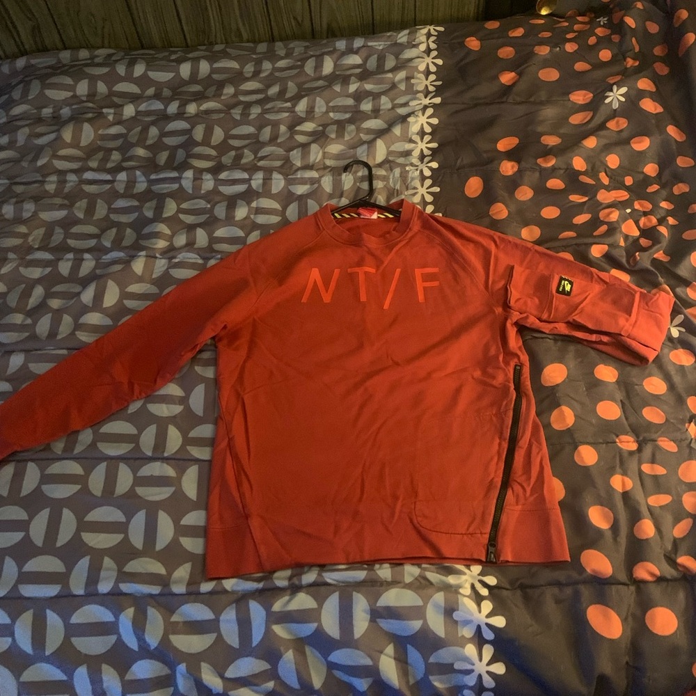 Orange Long Sleeved Nike track/field shirt.